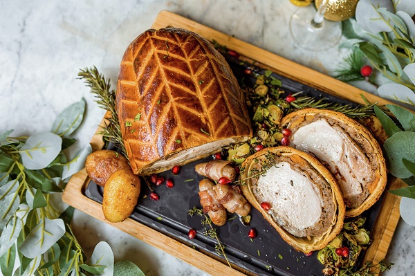 A flat lay image of a christmas wellington (food).