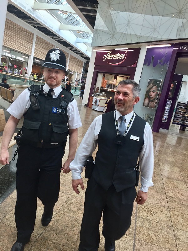 Police officer and Security man at Meadowhall stood together