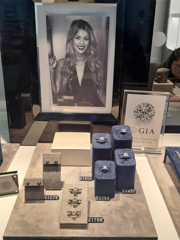A jewellery shop window display with rings and earrings.