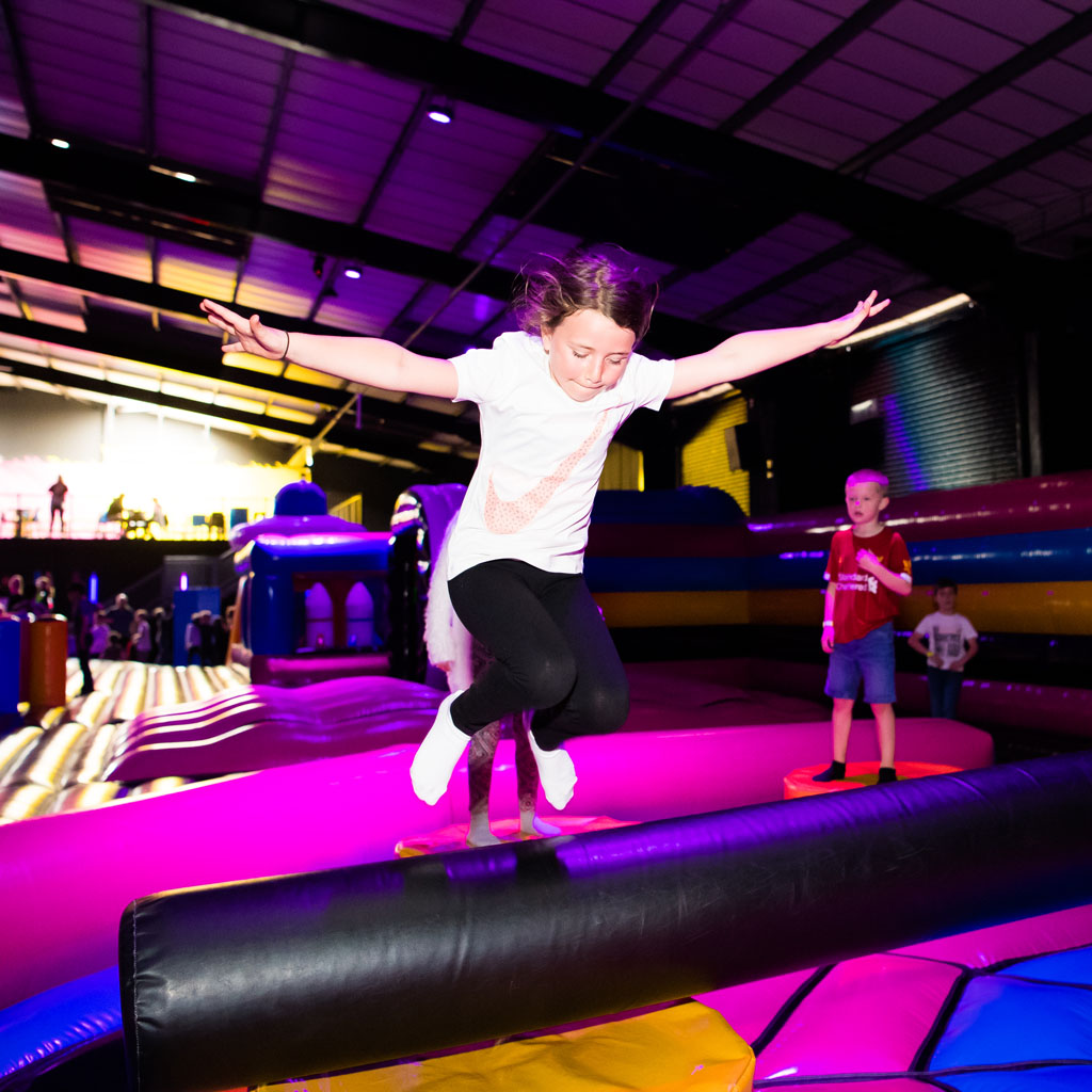 image of girl bouncing on inflatables.